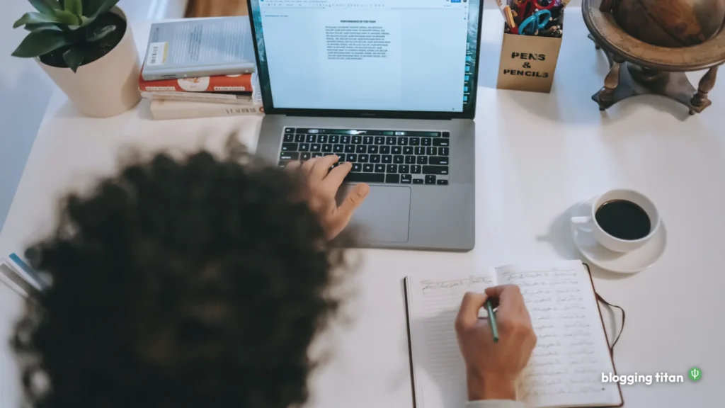 Writer at a desk typing on a laptop beside an open notebook, deciding between Substack and a WordPress blog